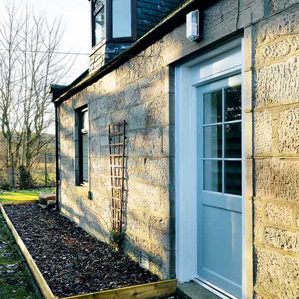 stone cottage with light blue front door