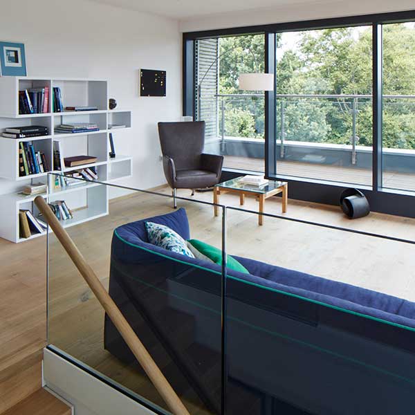 upstairs lounge space with balcony overlooking tree space