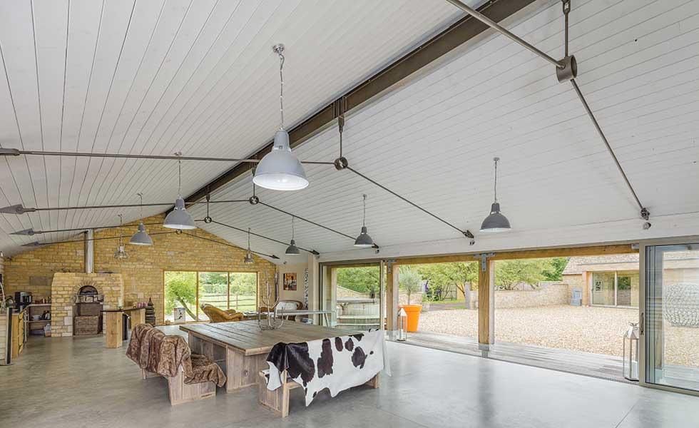 Barn conversion with poured concrete floor sliding doors and indoor pizza oven