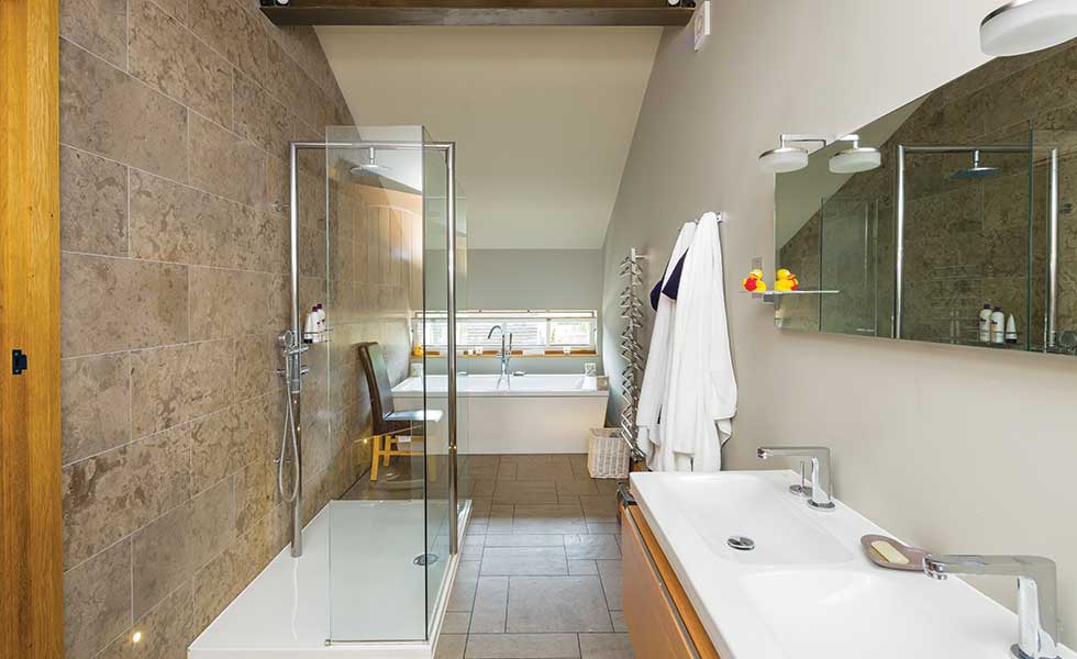 Barn conversion master bathroom with walk in shower