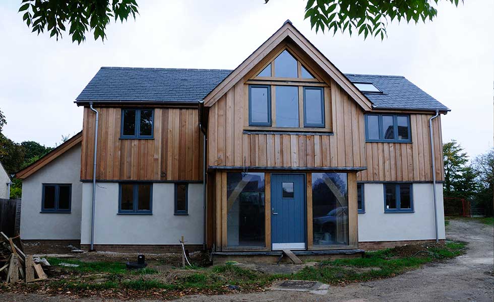 white rendered and timber clad oak frame and hempcrete home