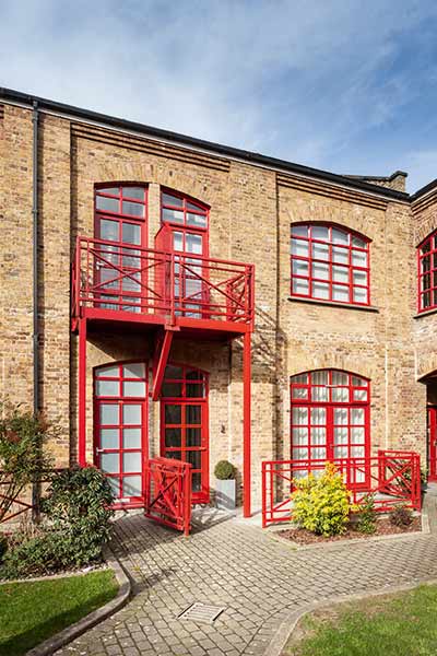 A former bible factory clad in brick has been converted into a contemporary family home