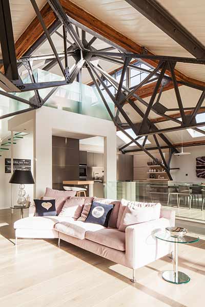 The ceilings within this power station conversion feature the original steelwork for a contemporary feel