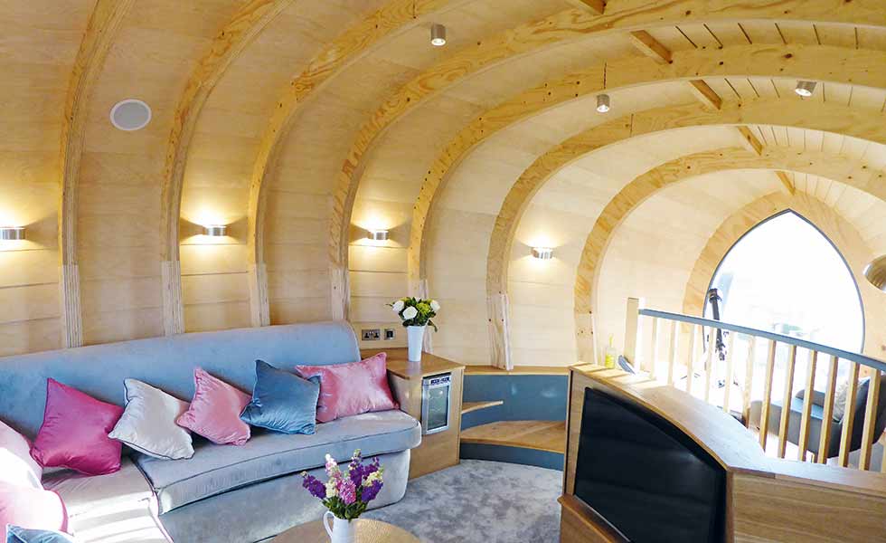 Showing how commercial conversions can become comfortable homes, the top floor of this former windmill boasts a cosy living space with views out over the countryside