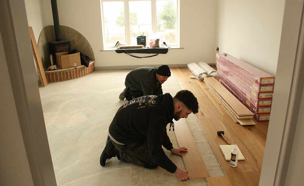 Before moving in, the trades get to work laying the flooring in David's self build
