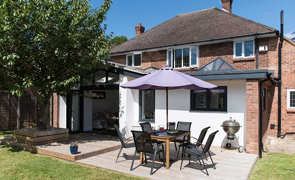 This rear extension has been clad in white render to contrast against the 1950s brick building