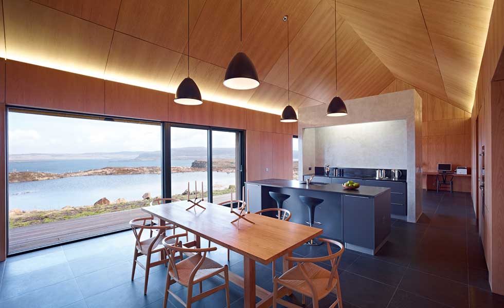 In this project by Dualchas, vaulted ceilings allow the illusion of space