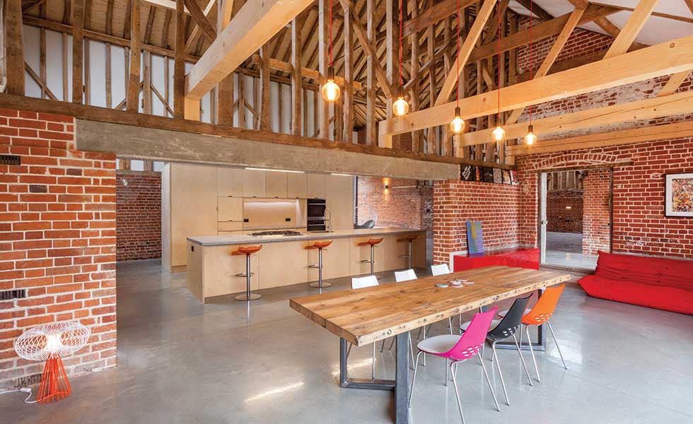 A warm roof allows the barn's original rafters to remain visible