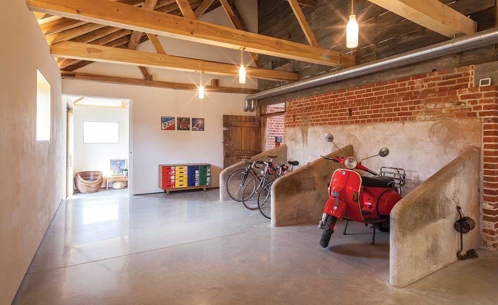 Concrete dividers, originally part of the barn's milking parlour, have been converted into bays for bicycles and motor scooters