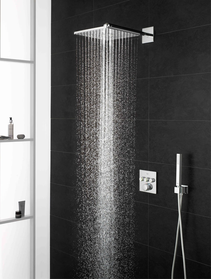 shower running against black tiles