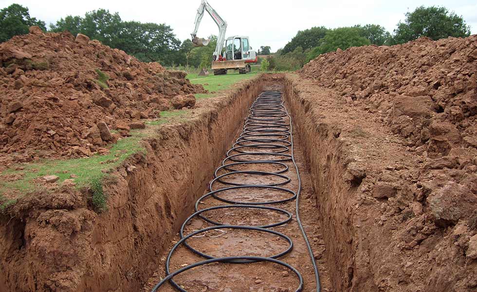 • GSHP slinky trench – For sites with limited land a slinky trench should not be instantly be discounted; efficiency improvements to the home can reduce the amount of ground array required, and even reduce the size of heat pump, offering further cost saving advantages