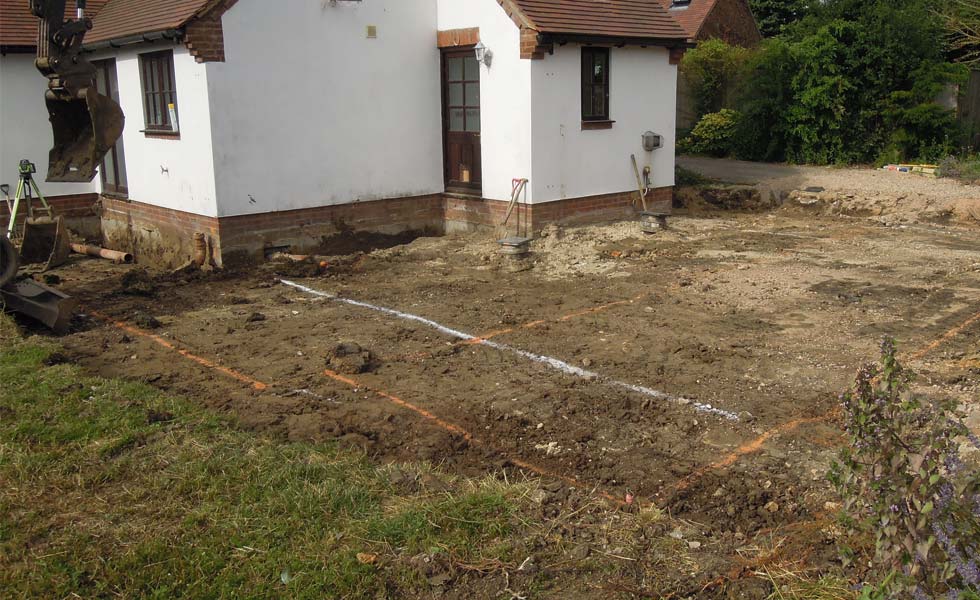 The oversite is cleared before the trenches are dug for the extension