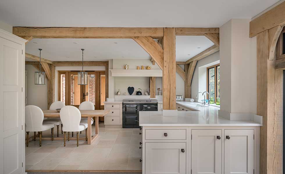 Open plan Shaker style kitchen with exposed beams