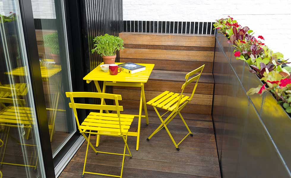 terrace with yellow bistro table and chairs