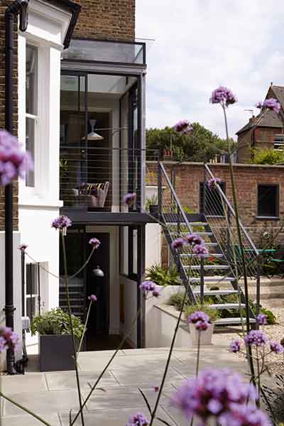 This two storey glass box extension is topped with a glass roof