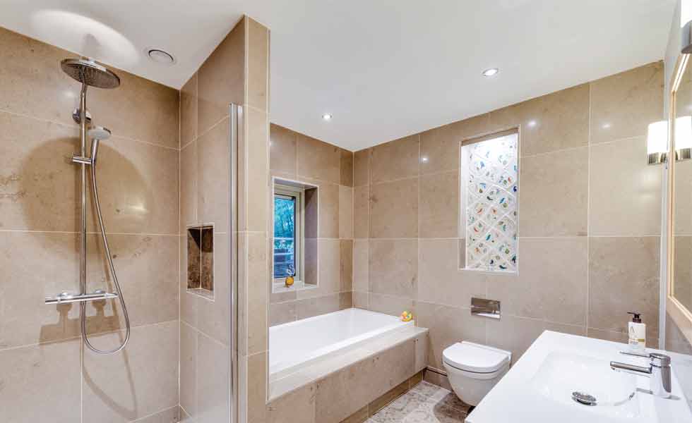 En suite bathroom with stone stiles and walk-in shower