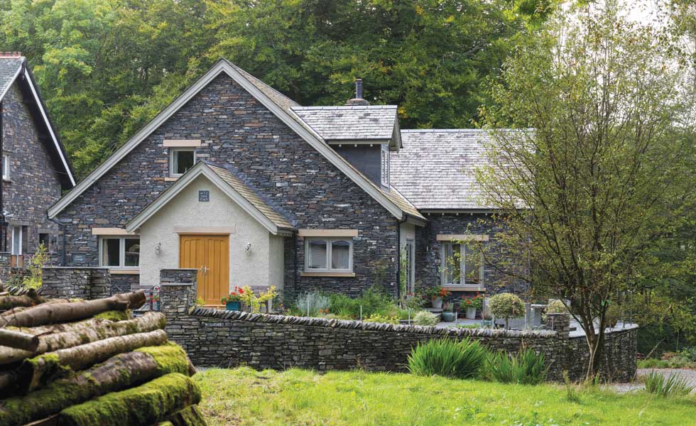Timber frame self-build with stone cladding and render