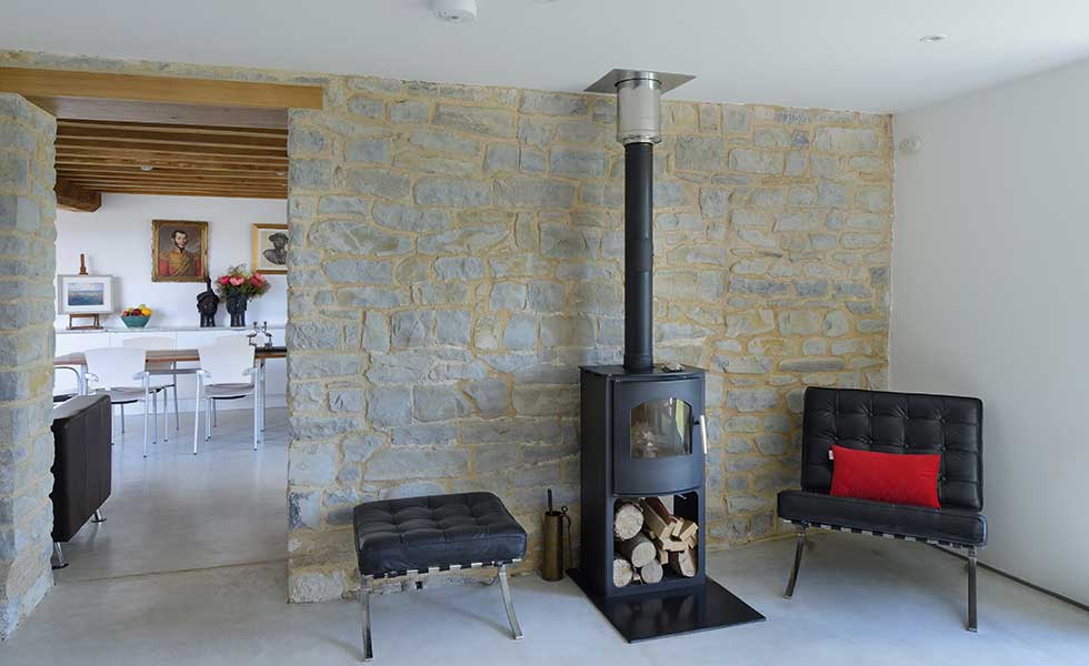 Living room with woodturner and exposed stone walls