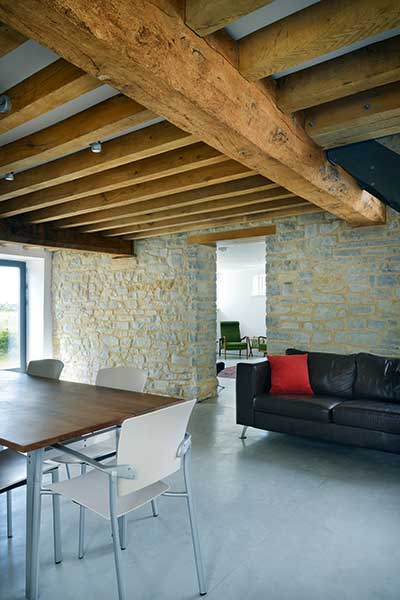 Barn conversion living room with exposed stone walls