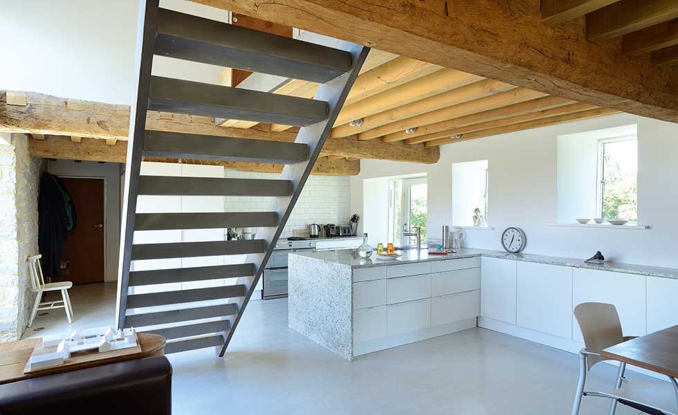 Open plan kitchen with contemporary staircase