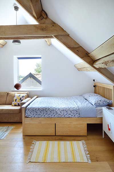 Barn conversion bedroom with exposed beams