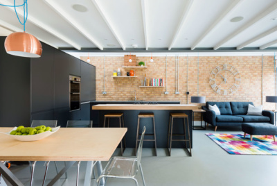 modern kitchen diner with exposed brick wall