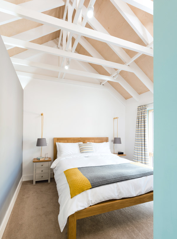 Master bedroom with vaulted ceiling and exposed beams