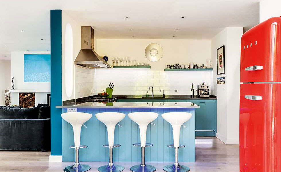 blue kitchen with partition red fridge