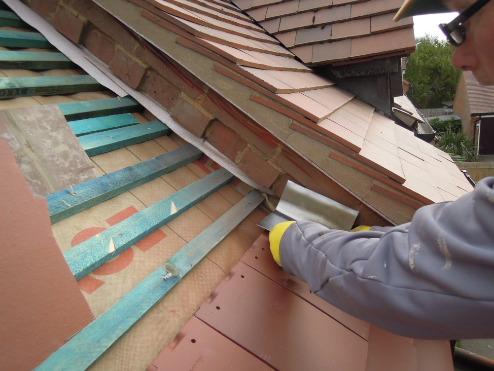 lead soakers fitted to tiles on roof of extension