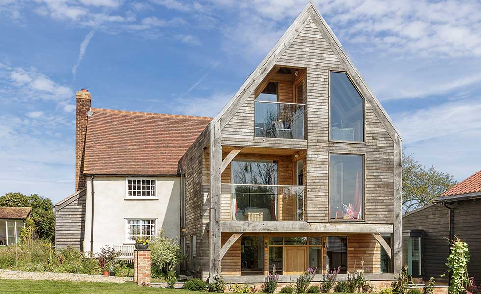 This triple storey oak frame extension by Oakwrights offers much needed additional space