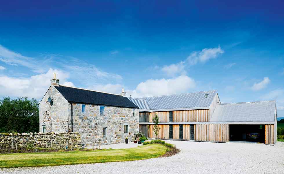 A two storey timber clad extension has been added as a separate wing onto this farm building