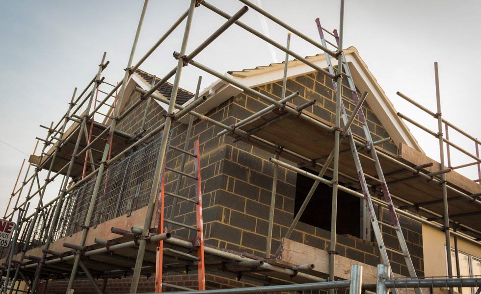 Brick extension to house with scaffolding