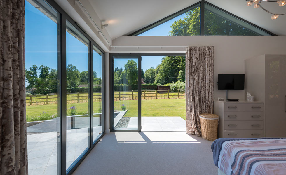 Bringing light into the bedroom with bifold doors and fixed glazing