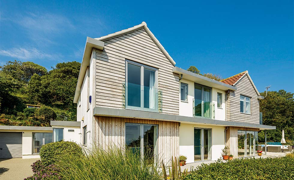 Coastal renovation clad in weatherboarding and render