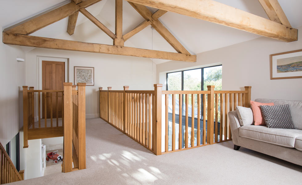 Mezzanine snug or study area with exposed oak trusses