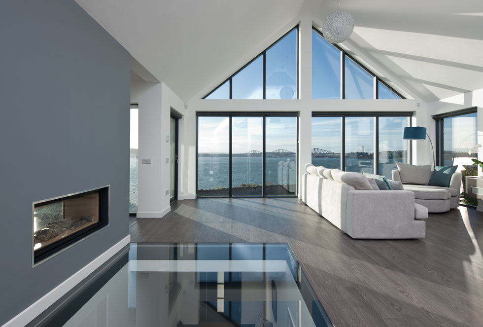 fixed glazing in the living room floods the space with natural light and makes the most of views