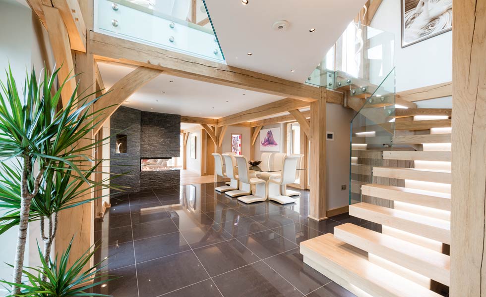 exposed oak beams and stylish contemporary staircase and dining area