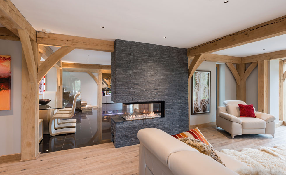 Broken plan layout with a statement fireplace between living and dining room