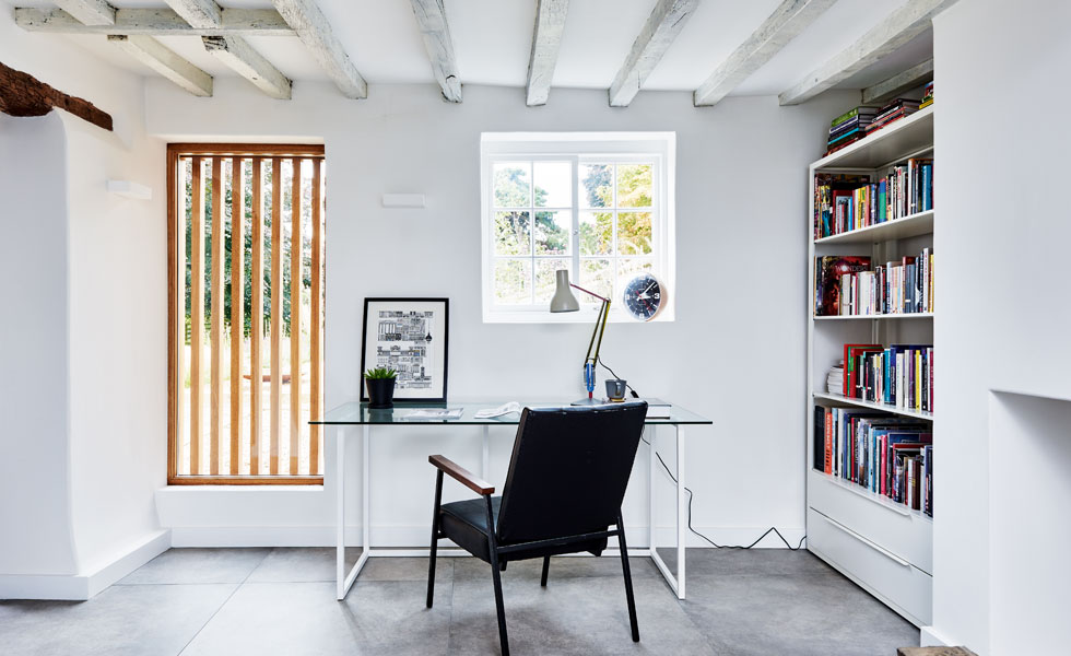 A former doorway has become a feature window thanks to the addition of some wooden shutters