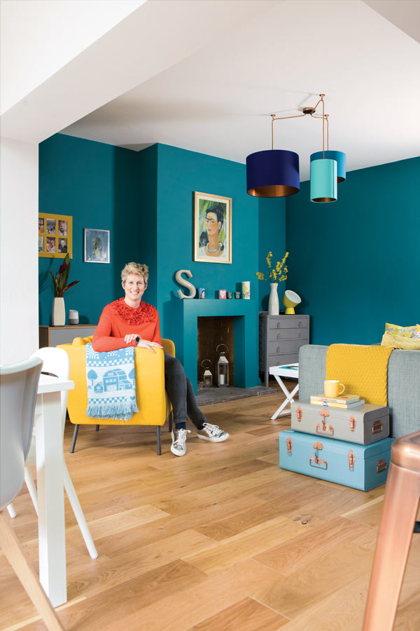 the sitting room has turquoise walls to help zone the space in the open plan layout