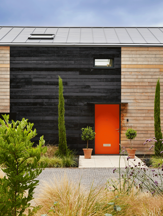 bright orange door on timber home