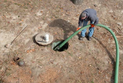 Man draining septic tank