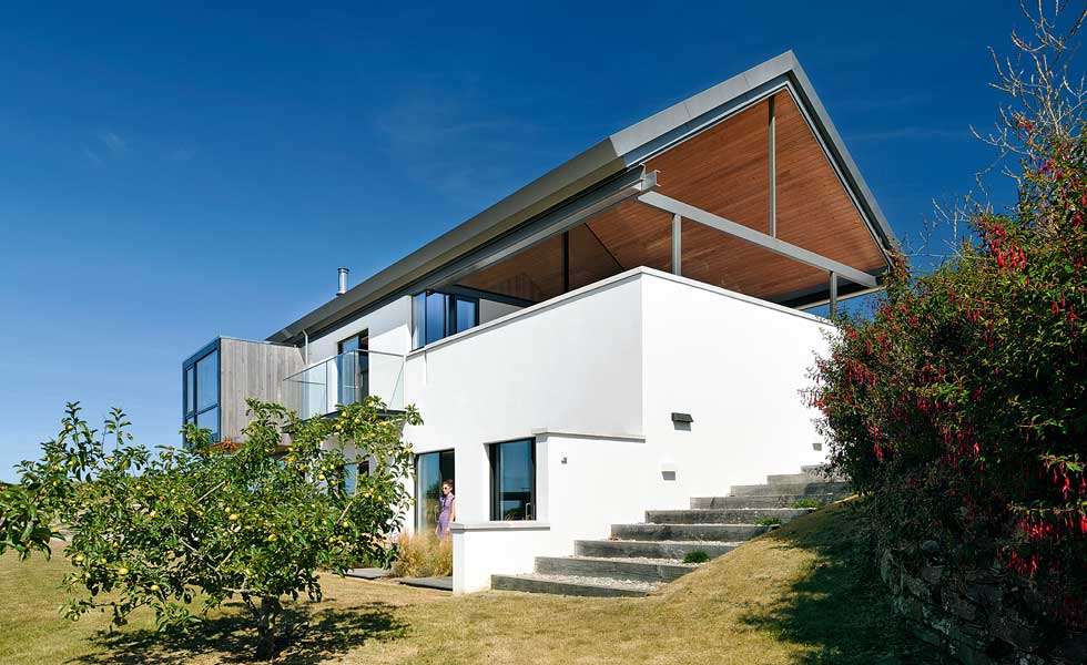 Render, timber cladding and fixed glazing comprise the property's exterior