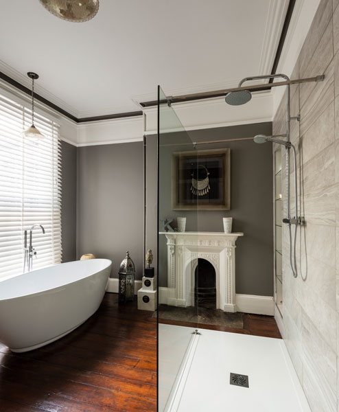 Contemporary bathroom with period fireplace