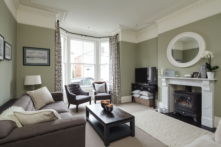 Living room with high ceilings and original features