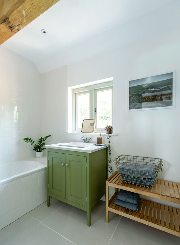 Bathroom with green vanity unit