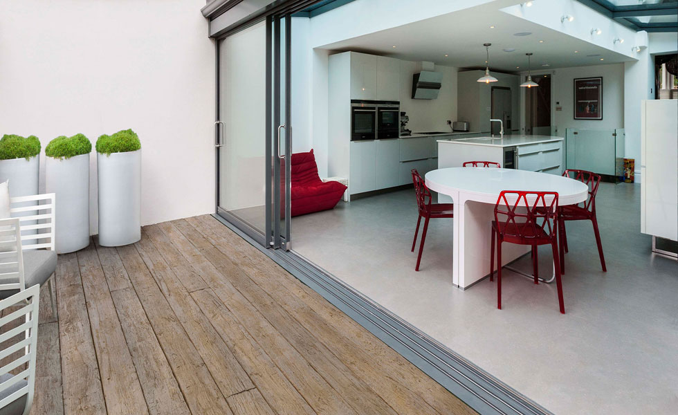Sliding doors leading to wood effect decking on terrace