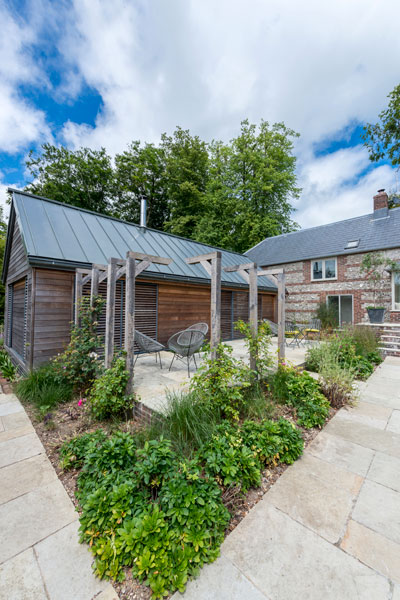 Stone house with timber clad single storey extension