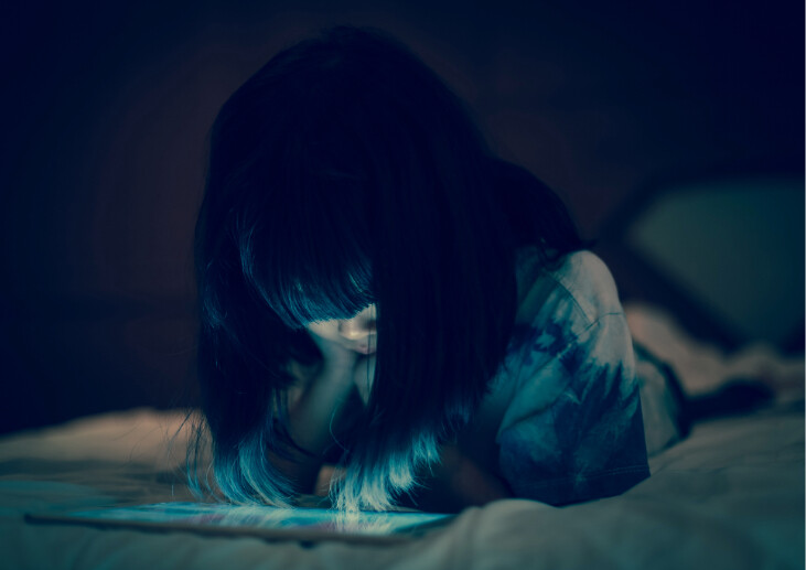 A child looking at an electronic tablet.