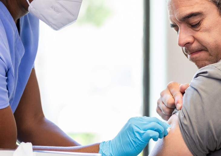 A healthcare worker administering a vaccine to a patient.